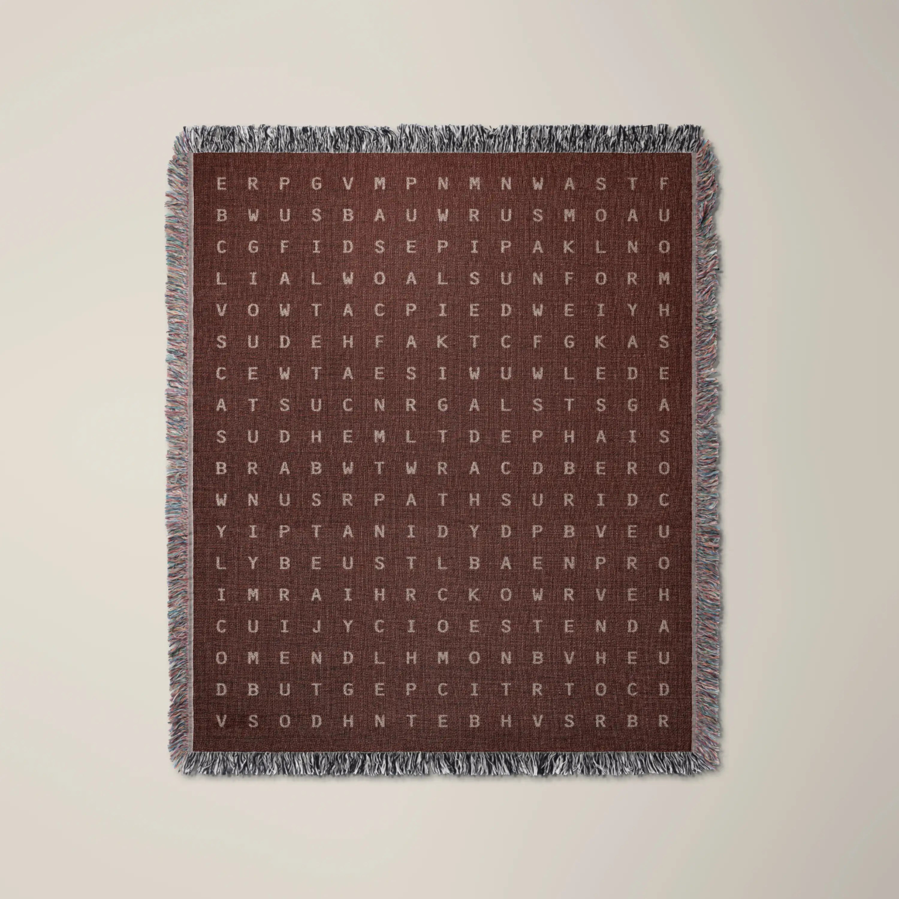 Becoming — No. 05 woven blanket in Garnet, a grid of cream letters across olive cotton with words woven into the pattern. #color_garnet