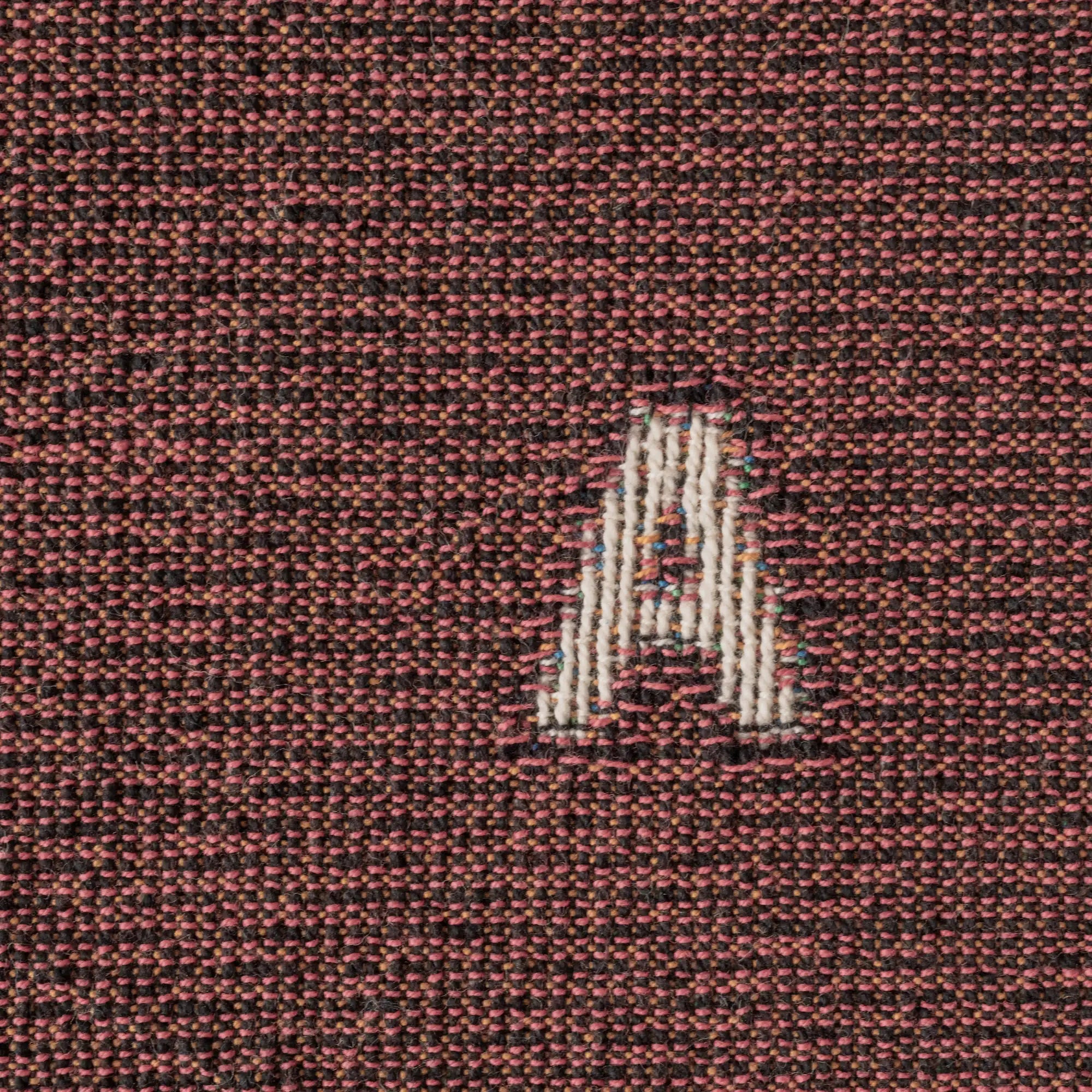 Love — No. 01 in Garnet, close up, with partial letters visible across the cotton weave. #color_garnet