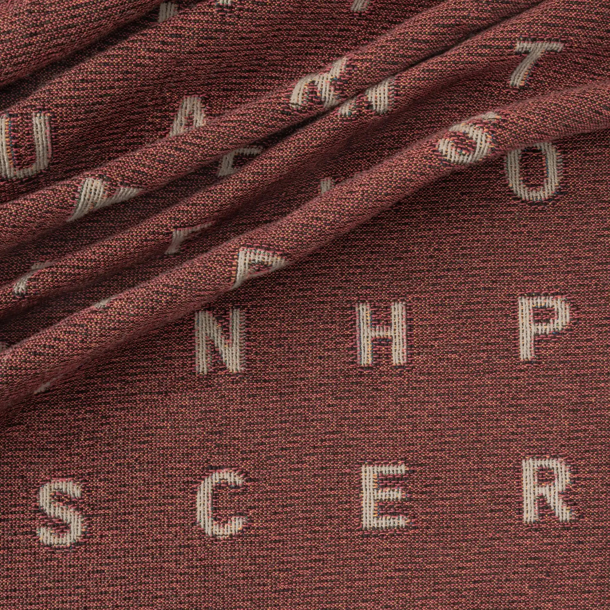 Love — No. 01 in Garnet, draped, with partial letters visible across the cotton weave. #color_garnet