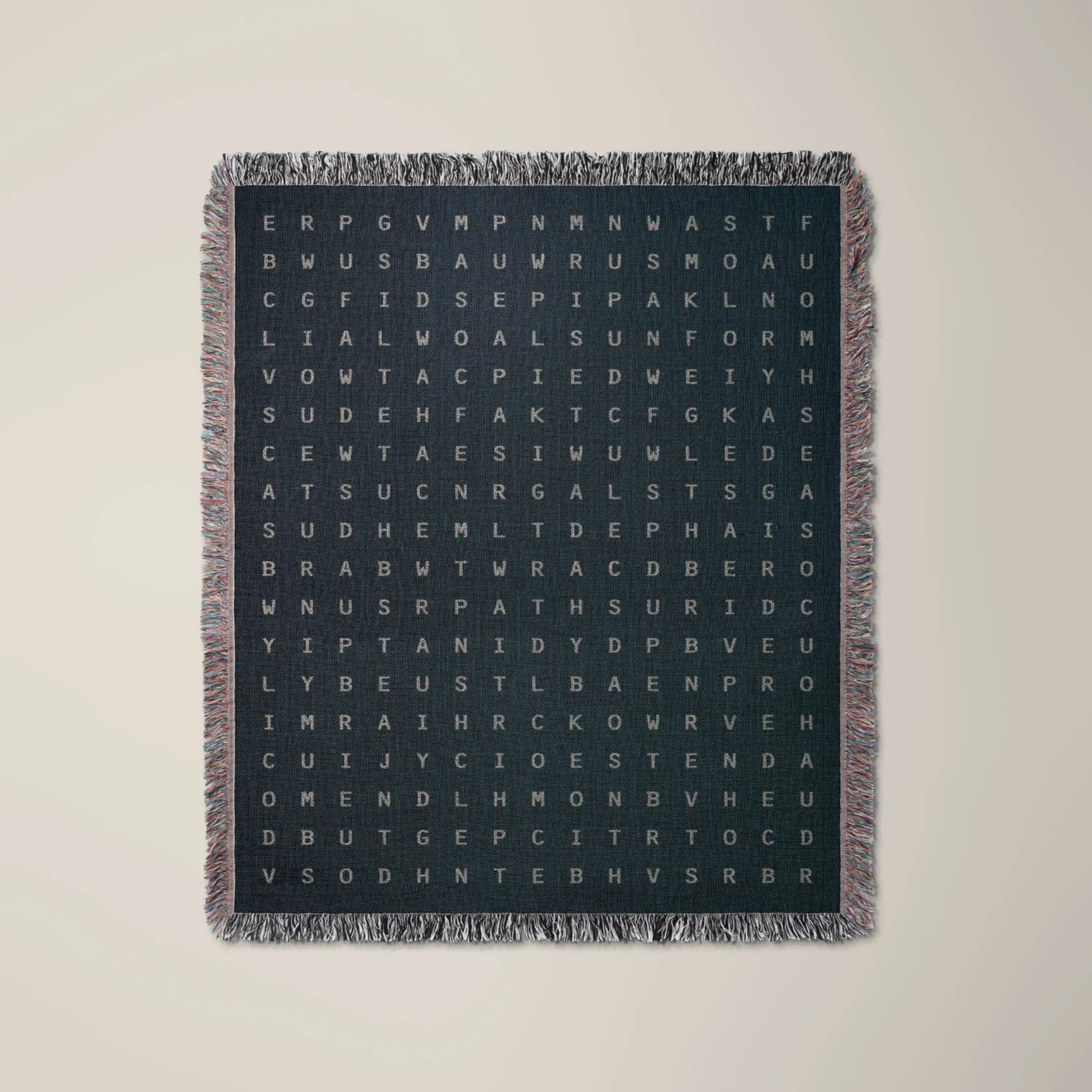 Becoming — No. 05 woven blanket in Navy, a grid of cream letters across olive cotton with words woven into the pattern. #color_navy