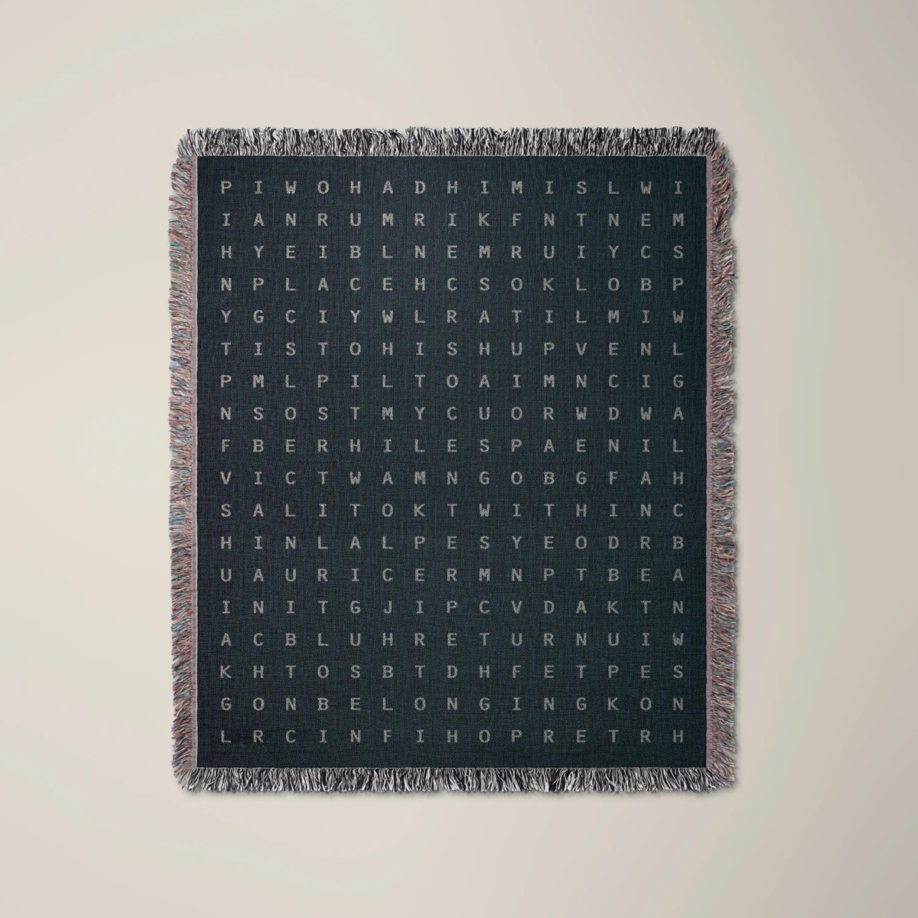 Home — No. 02 woven blanket in Navy, a grid of cream letters across olive cotton with words woven into the pattern. #color_navy