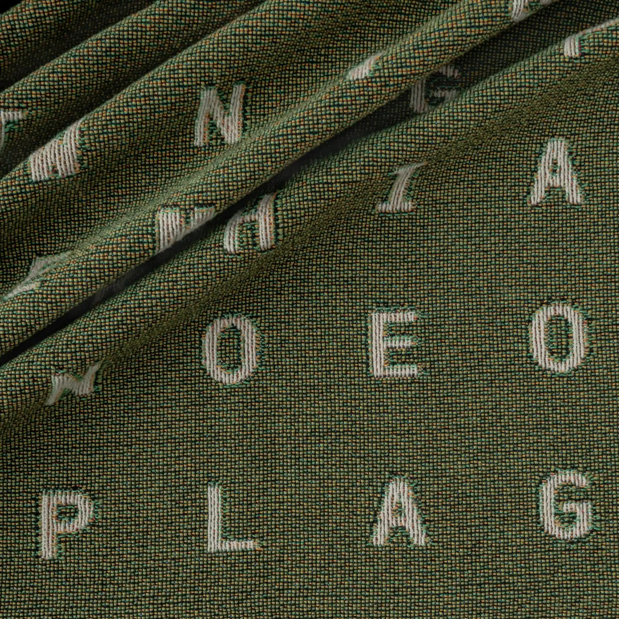 Love — No. 01 in Olive, draped, with partial letters visible across the cotton weave. #color_olive